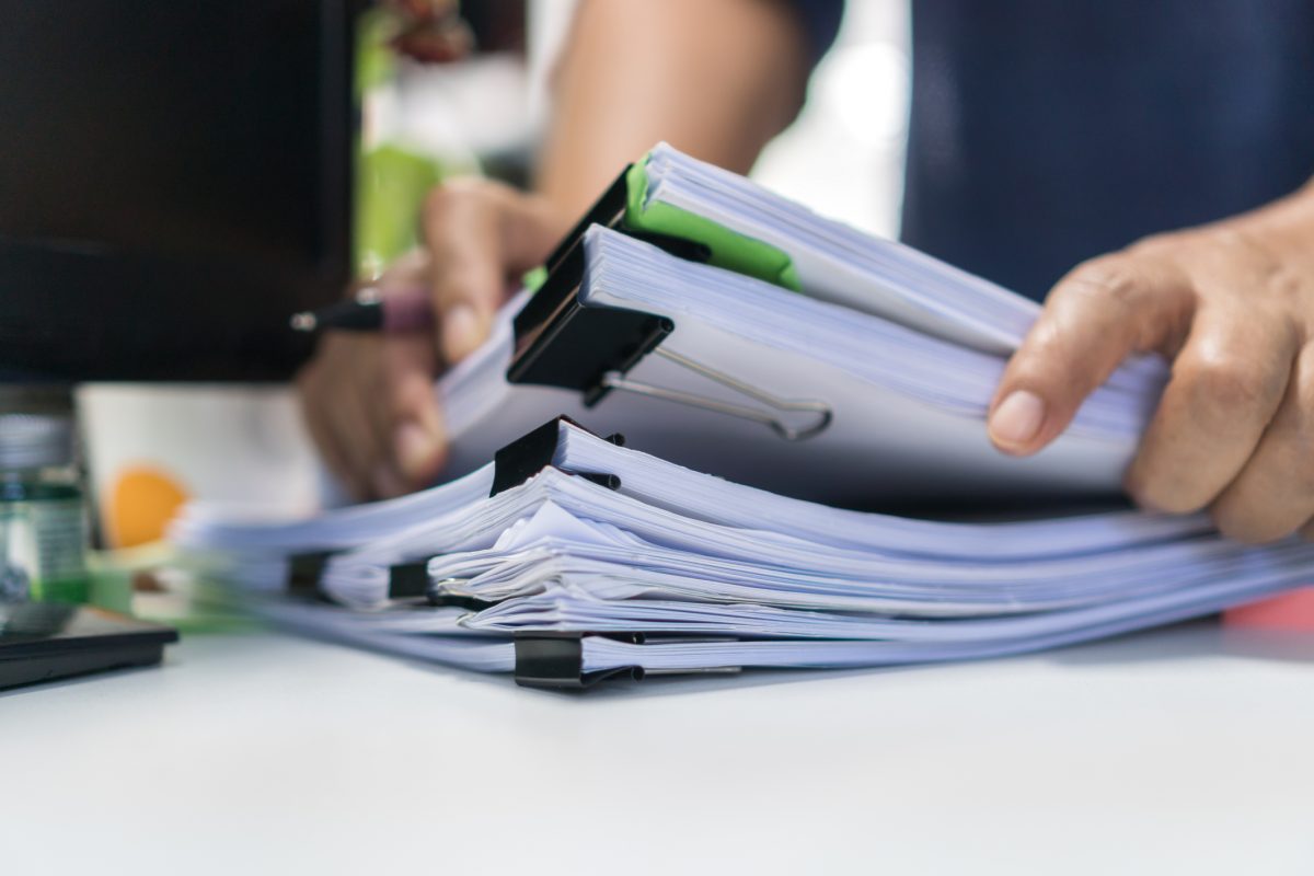 stack of paper data to be entered by data entry company
